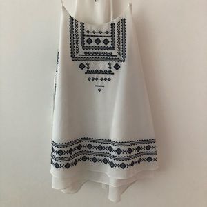 White blouse with blue embroidery